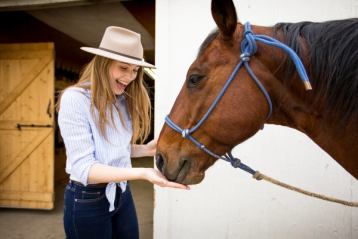 Woman feeding a horse