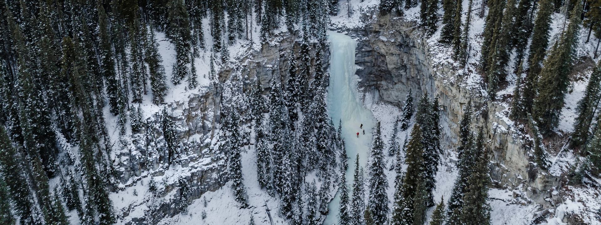 Aerial view of guide with couple in canyon