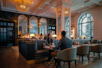 Couple enjoying drinks and food at the Fairview Lounge