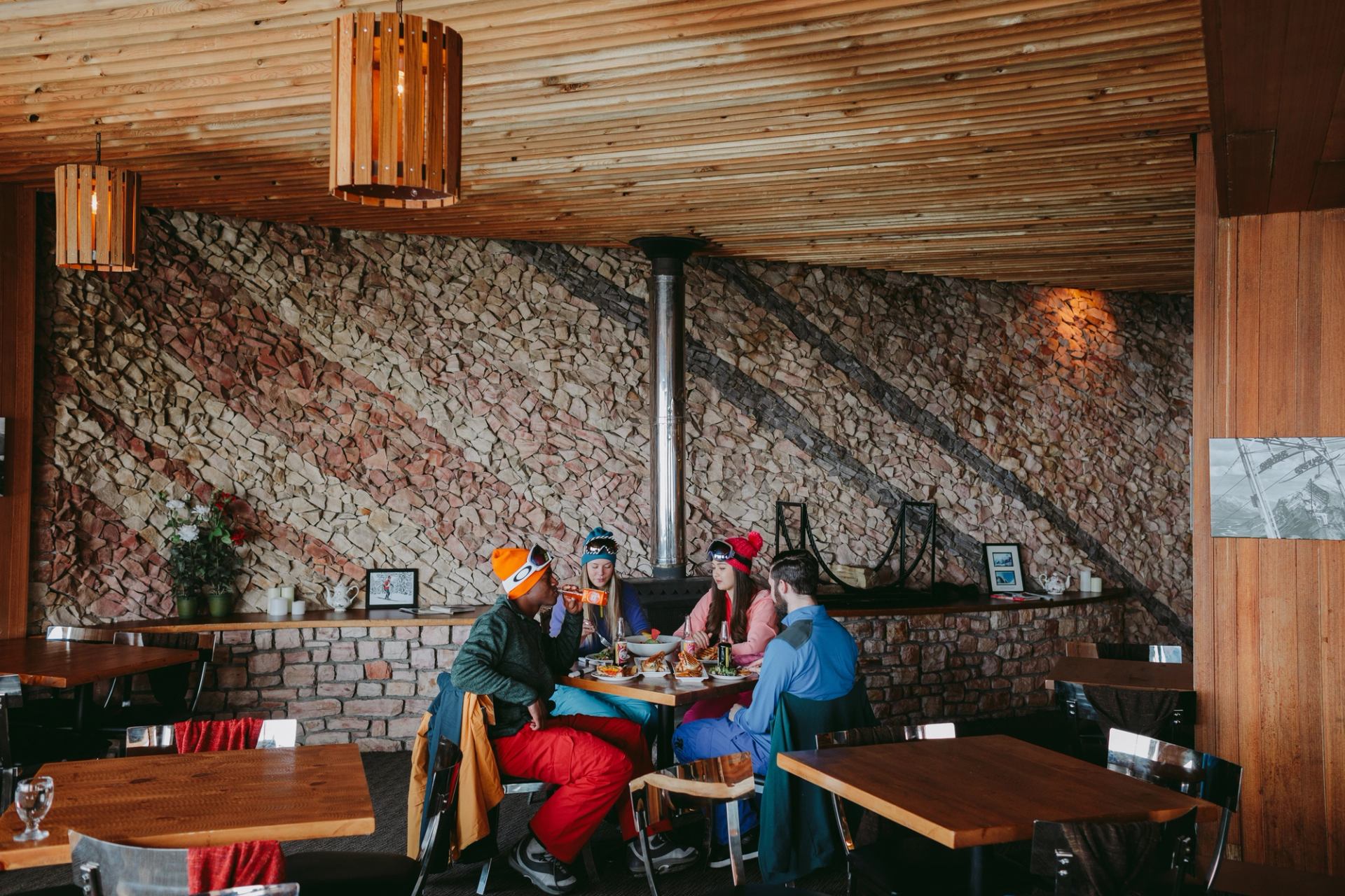 A group of friends enjoy a meal at the Cliffhouse Bistro at Mount Norquay.