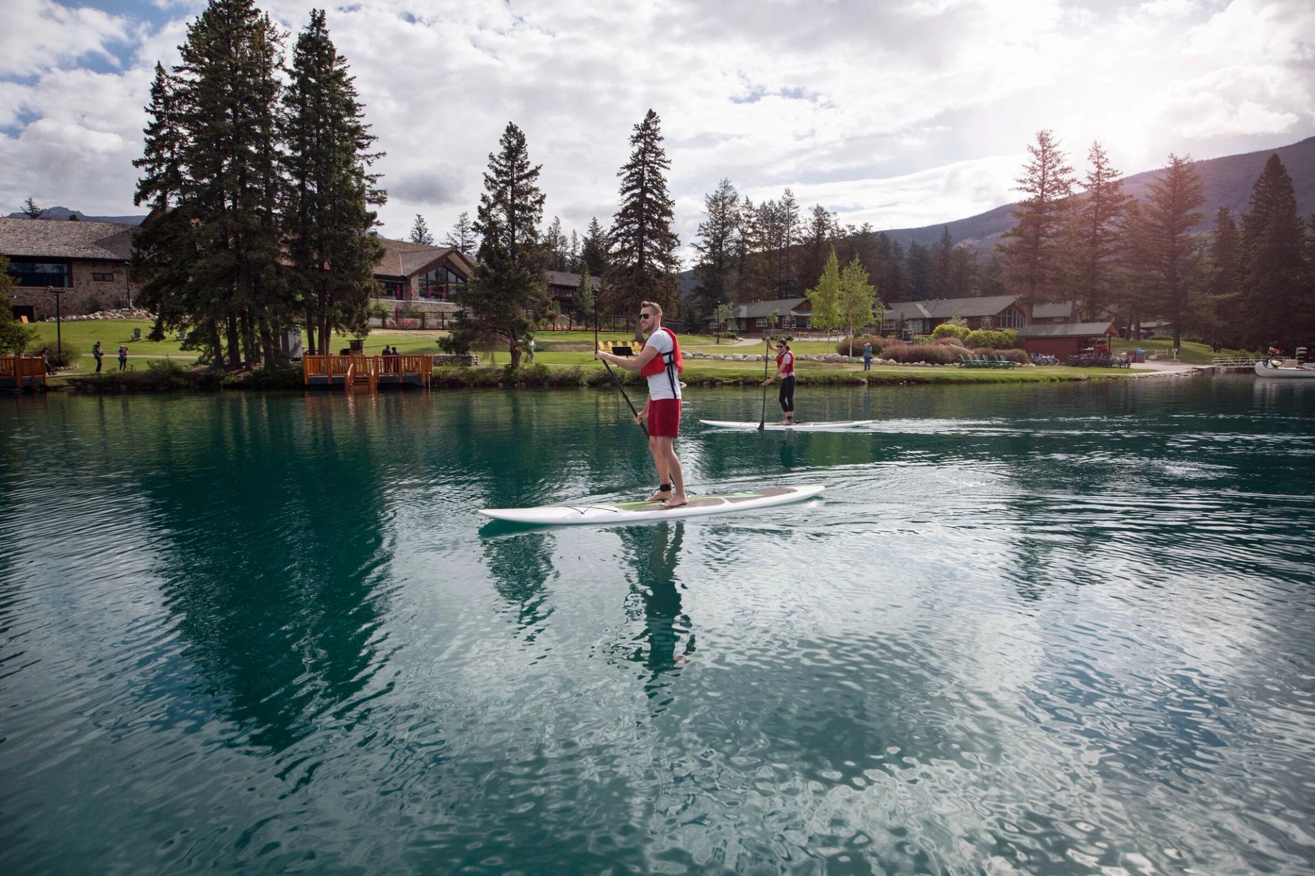 Man on stand up paddle board on Beauvert Lake.