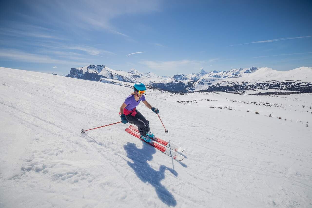 A women with her jacket tied around her waist, Spring Skiing at Sunshine Village in Banff National Park