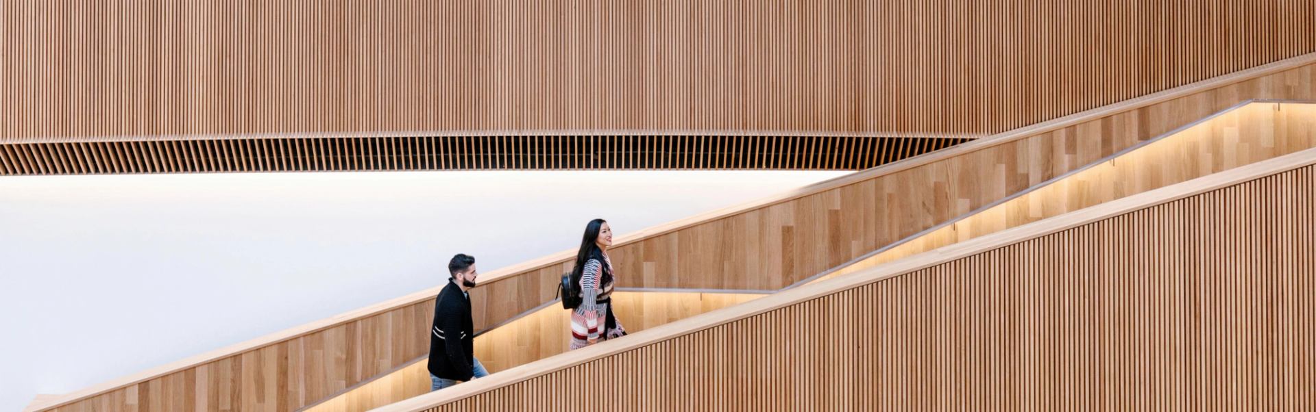 Couple walking up staircase at the Central Library.