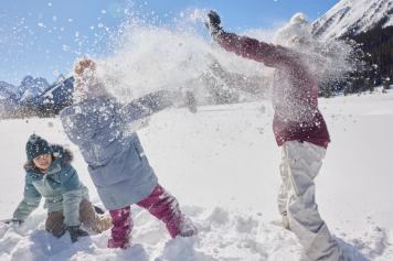 Three children playing in the snow at Mount Engadine Lodge