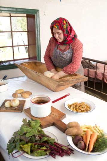 Costumed actor cooking a hearty meal at a Ukrainian Cultural Centre.