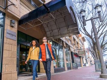 Couple walking outside of the Metterra Hotel in downtown Edmonton