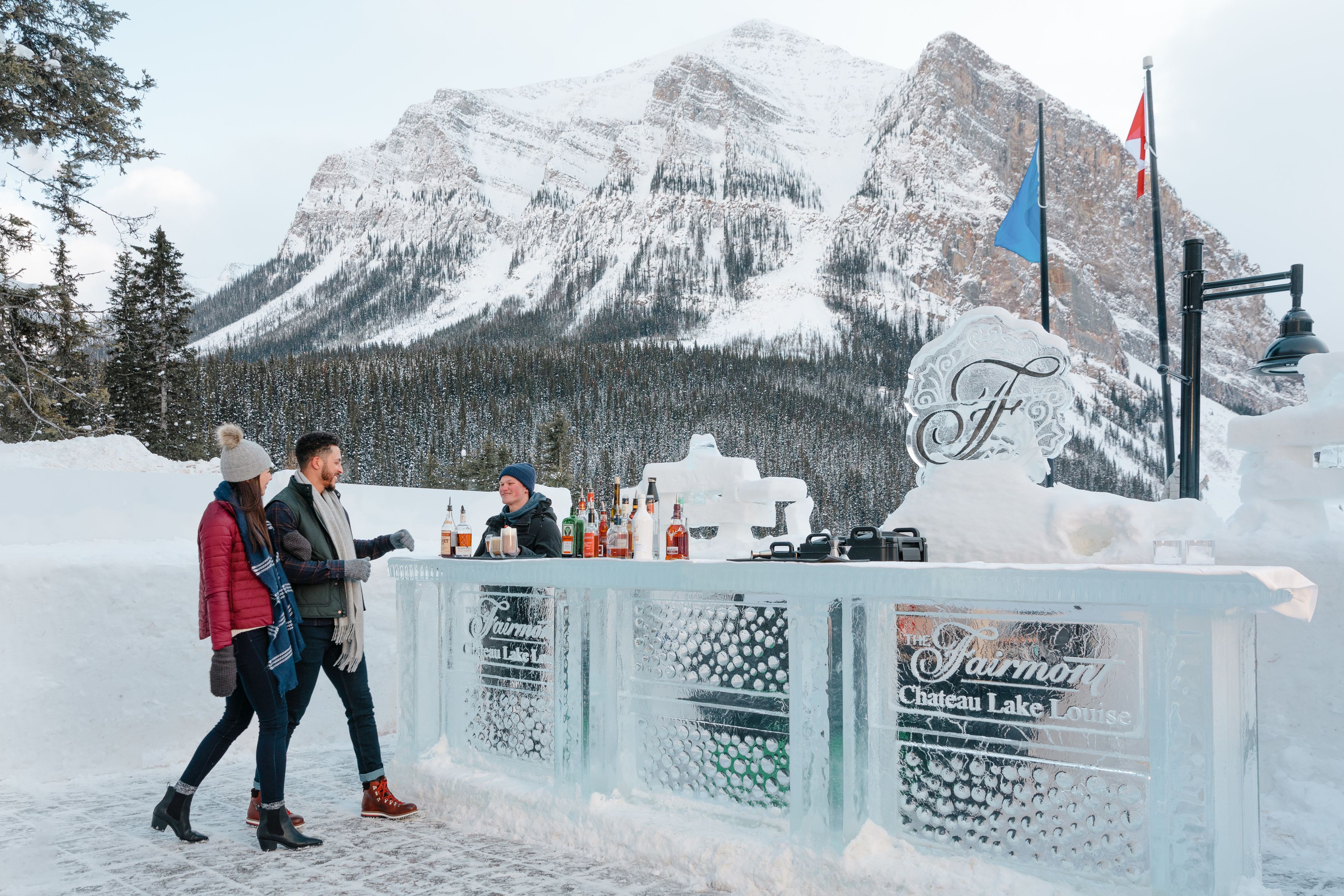 Couple enjoying drinks at the Fairmont Chateau Lake Louise Ice Bar in Banff National Park.