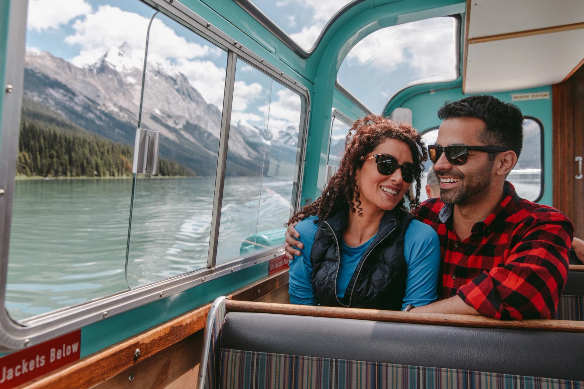 young couple on a boat tour on Maligne Lake