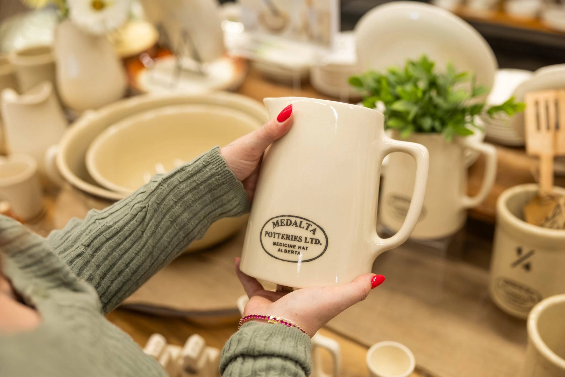 A woman admires a mug at Medalta.