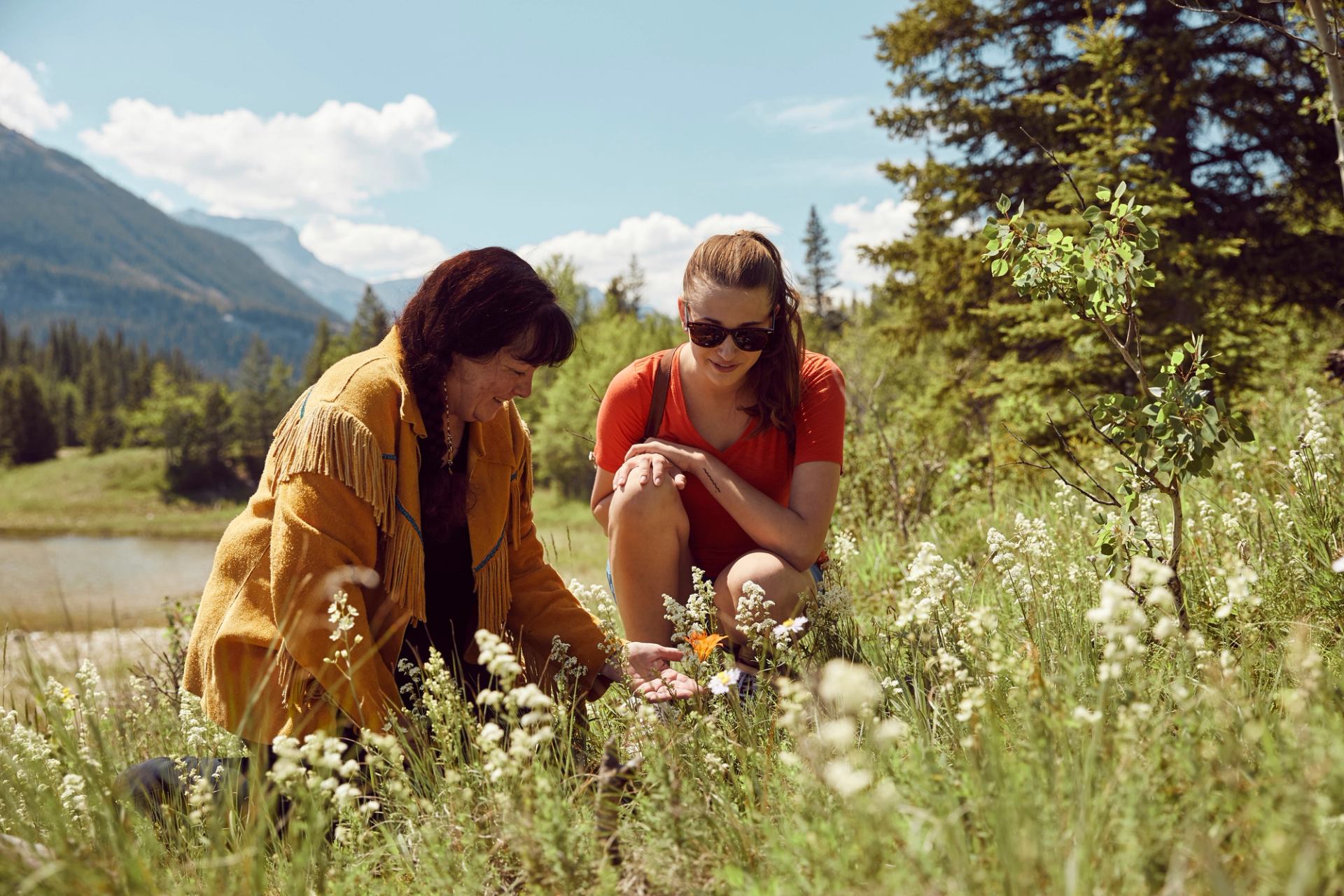 Two people on a medicine walk, where an Indigenous guide from Mahikan Trails teaches about the healing benefits of local plants.