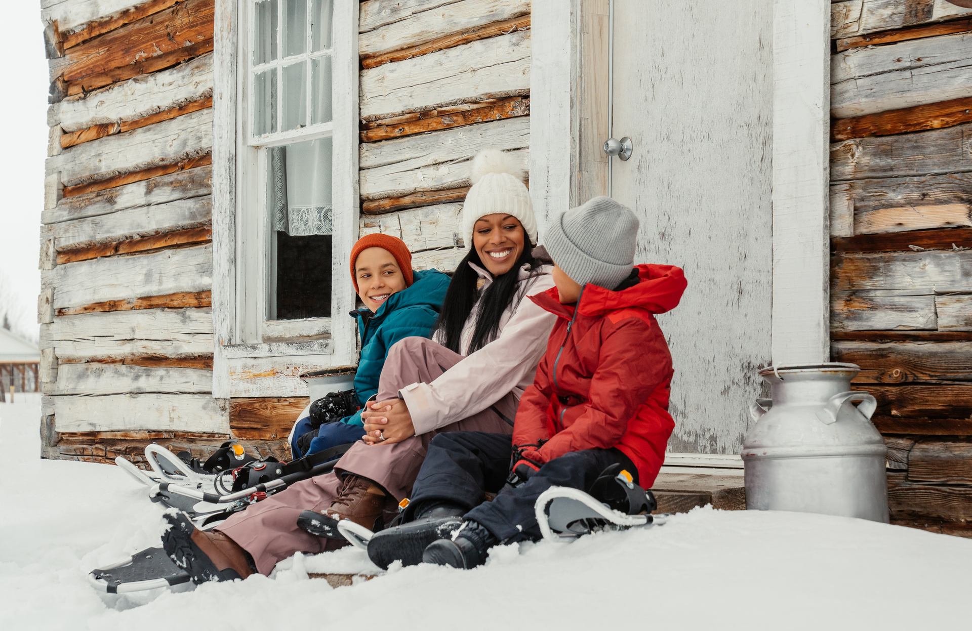 Family in front of cabin, one of the cultural experiences at Metis Crossing.