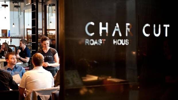 A server takes an order from a table of guests at CHARCUT in Calgary.