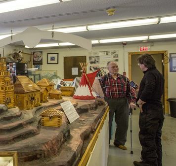 Two men looking at exhibits in a Museum.