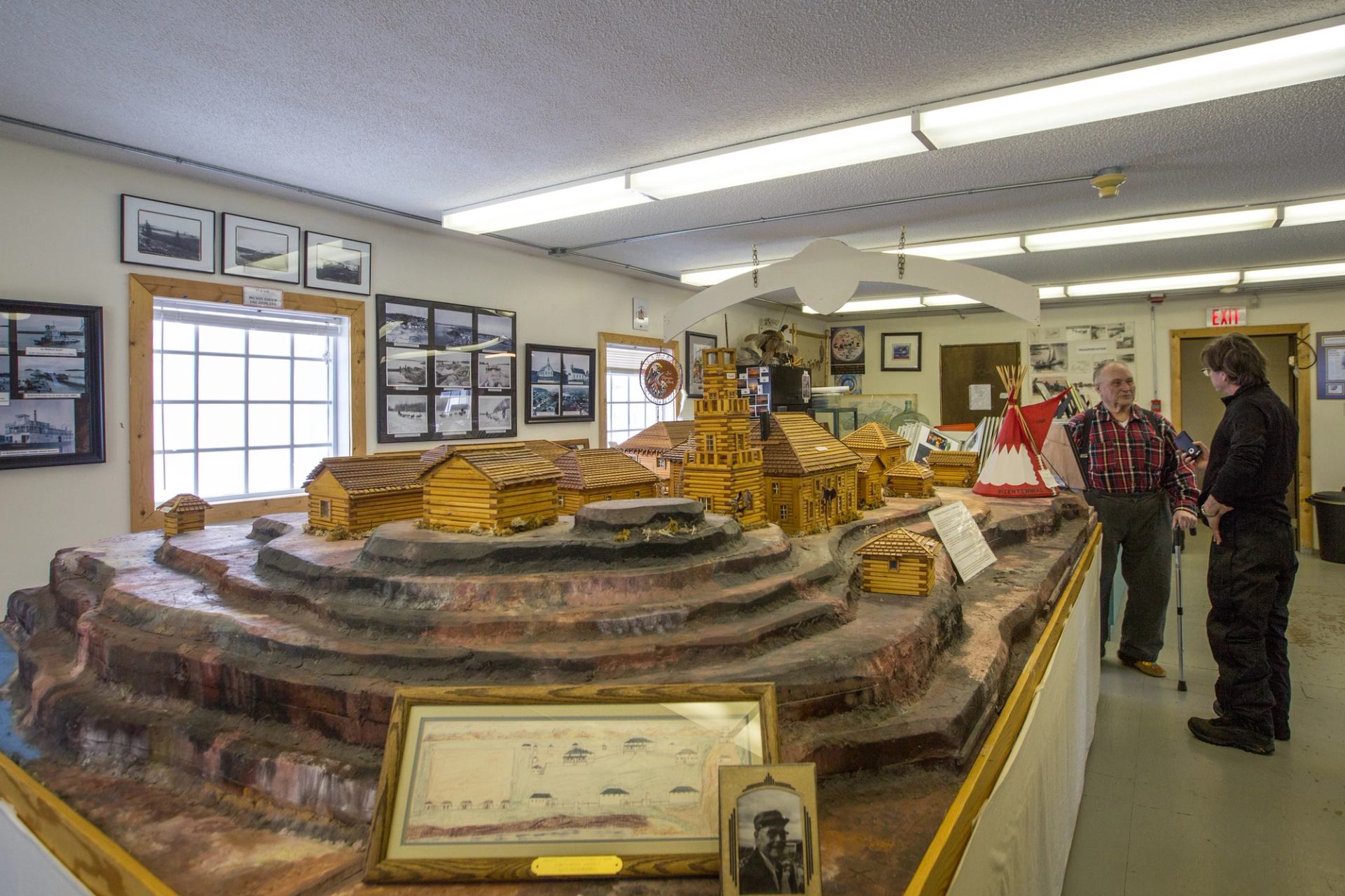 Two people on a museum tour at Bicentennial Museum in Fort Chipewyan.