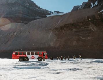 A group exiting the Ice Explorer bus onto a glacier
