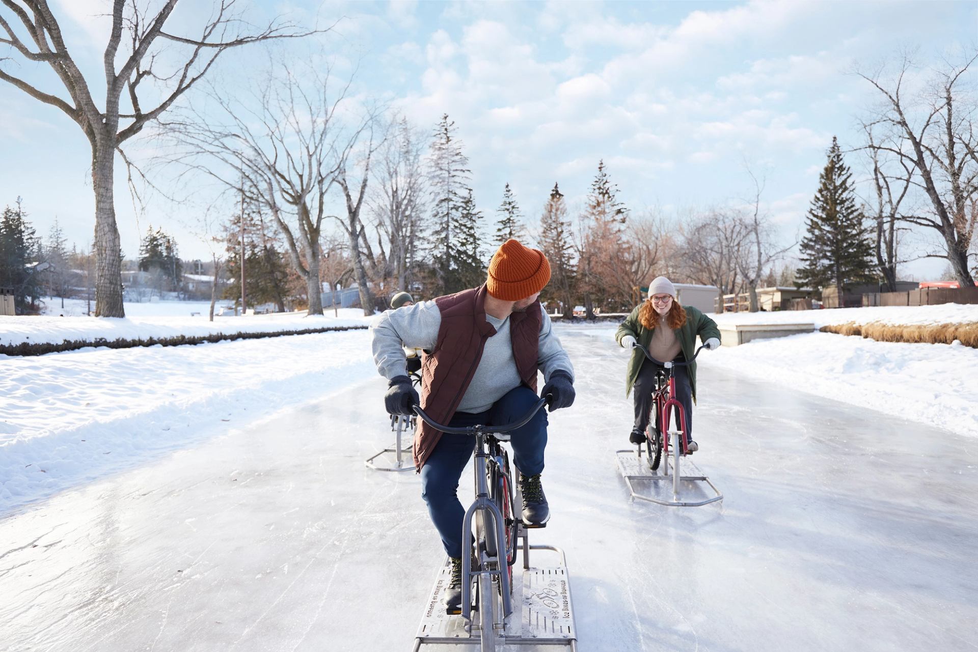 A group of friends ice biking at Bowness Park in Calgary.