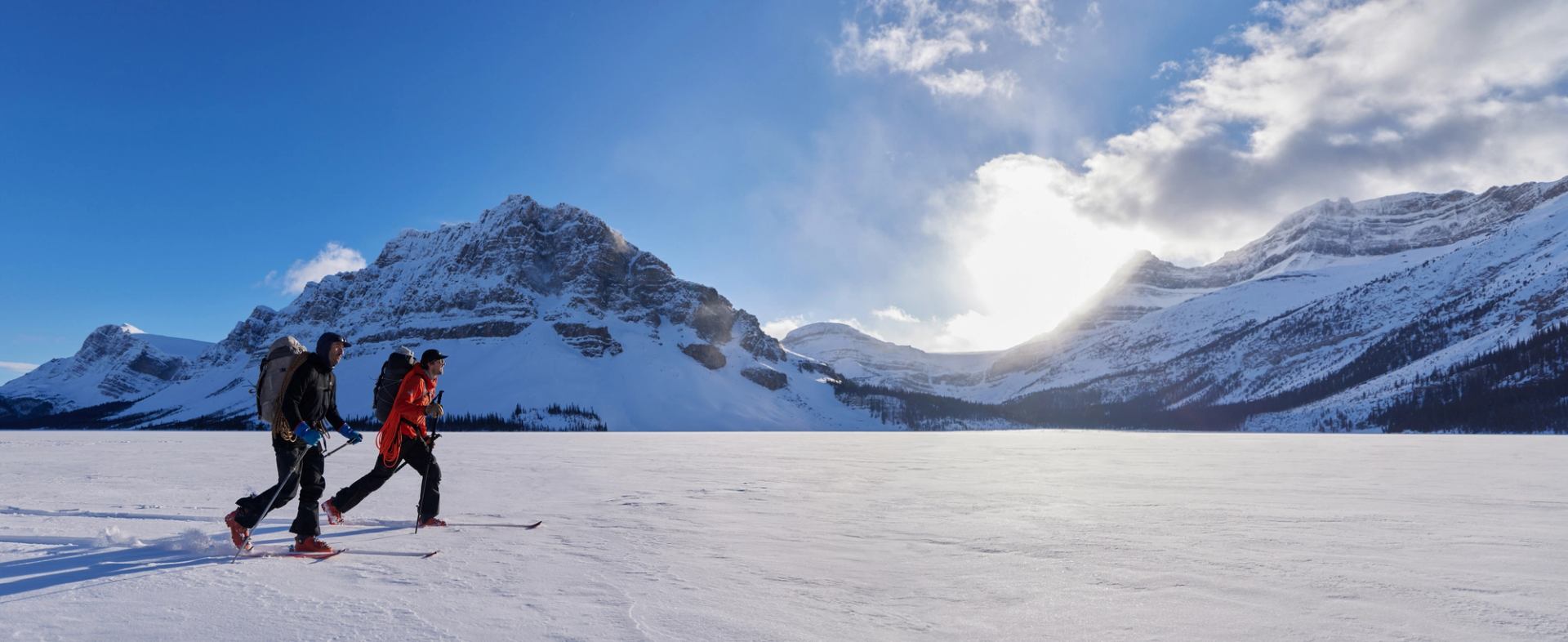 Two cross-country skiers gliding through Lake Louise Ski Resort.