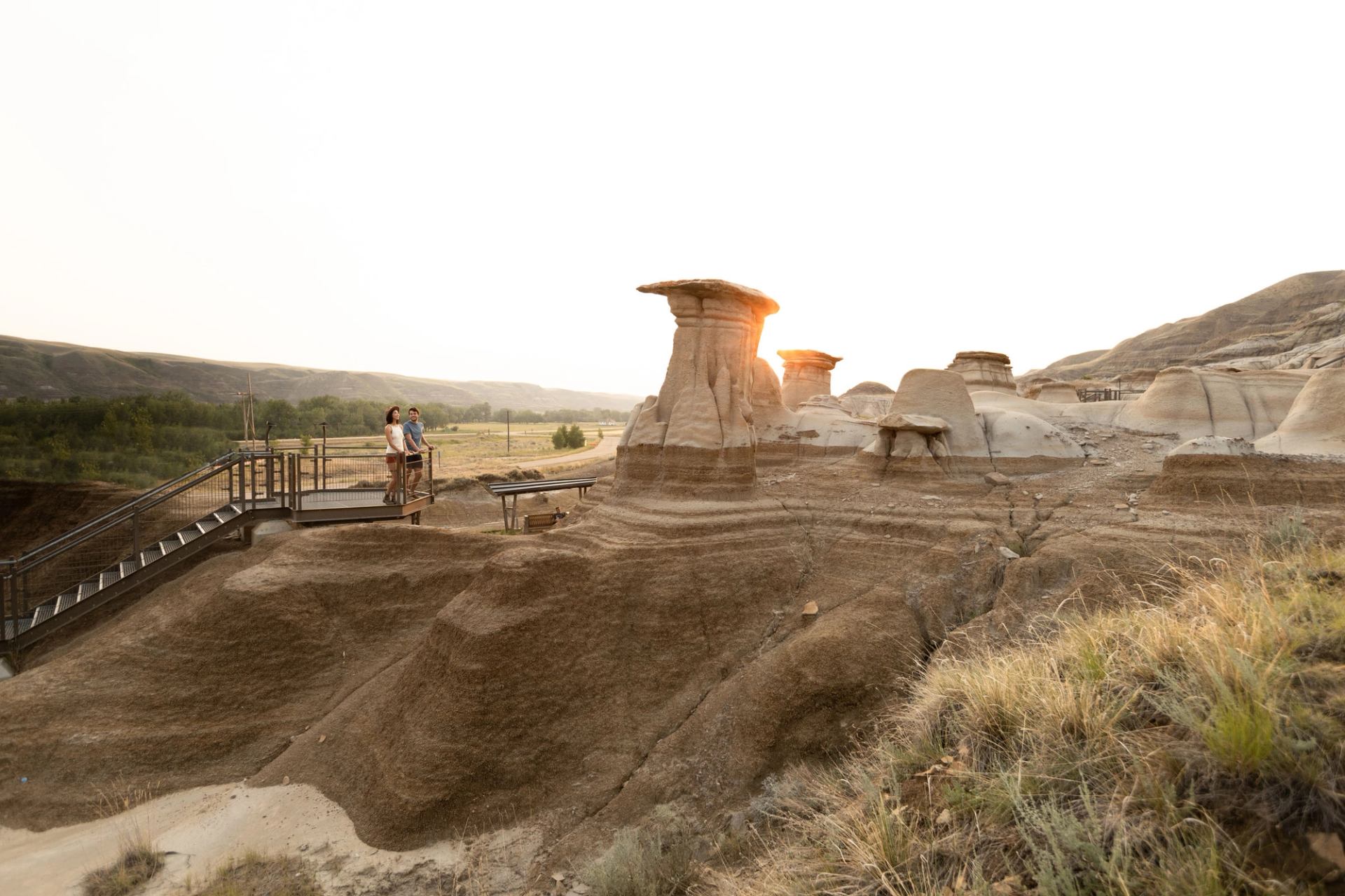 A couple views the hoodoos near Drumheller.