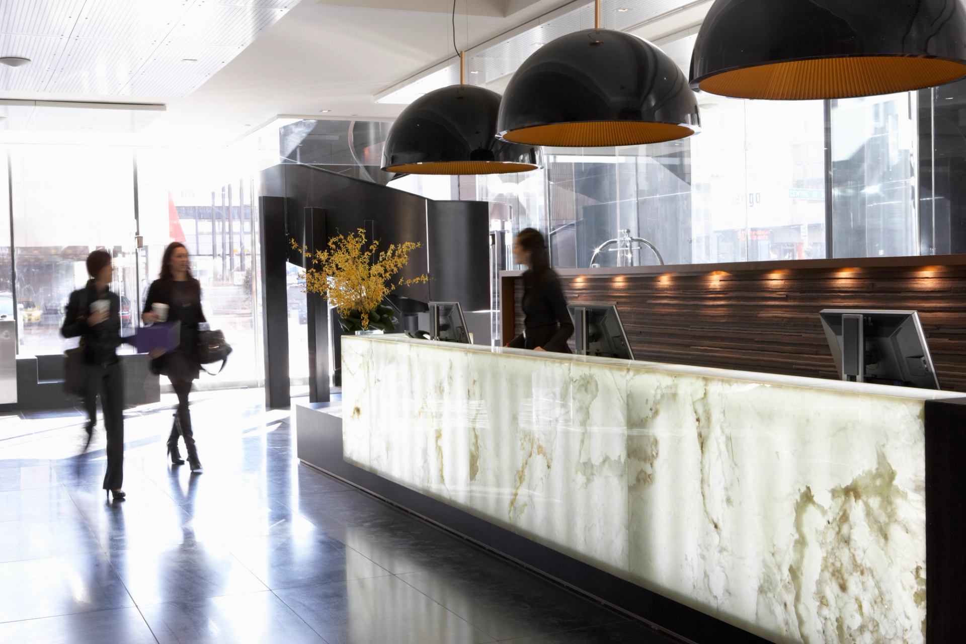 People walking into the lobby of Le Germain Hotel in Calgary.