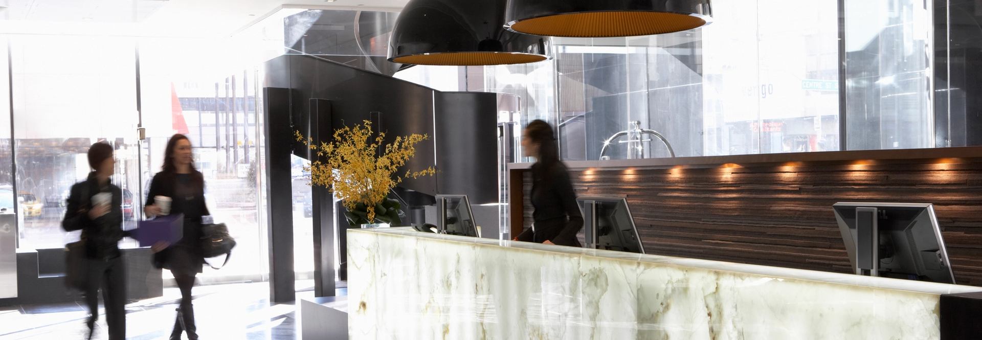 People walking into the lobby of Le Germain Hotel in Calgary.