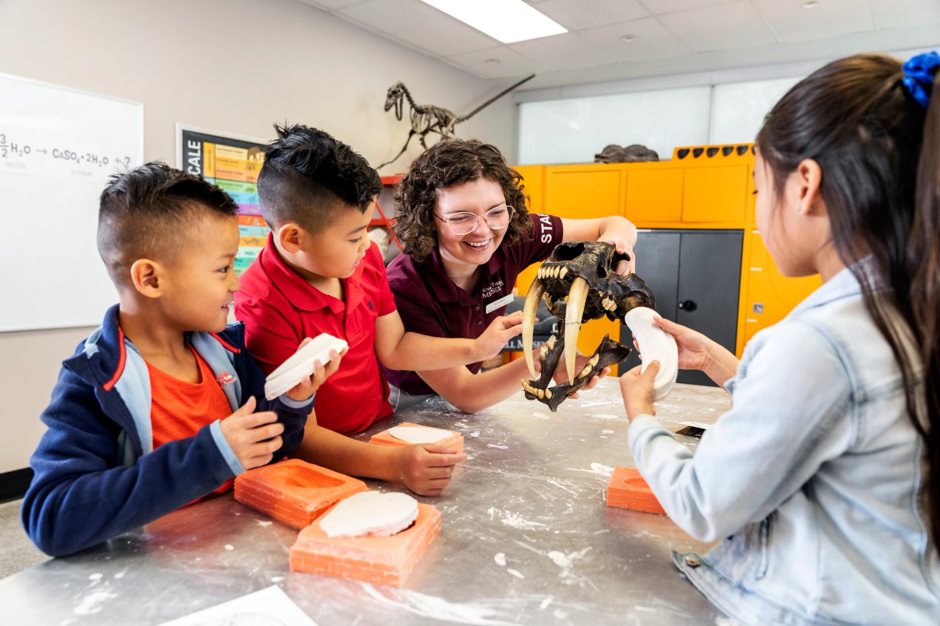 Kids working on the fossil casting as an interactive activity at the Royal Tyrrell Museum in Drumheller.