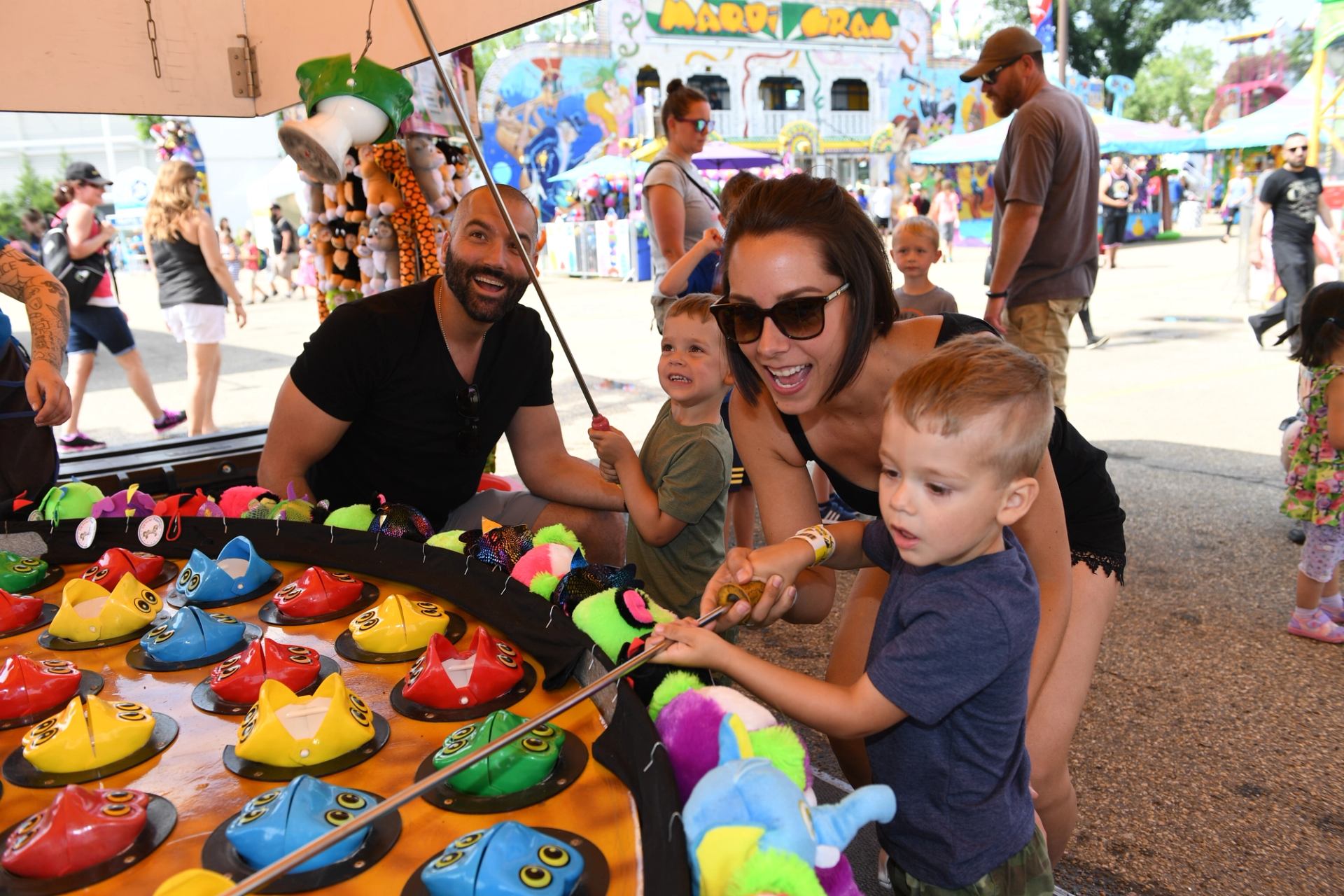 A family plays a game at a midway