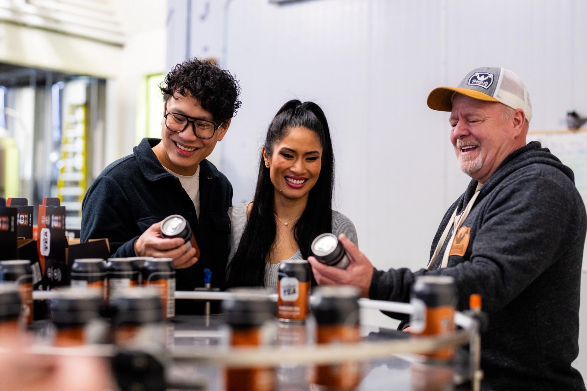 Couple looking at samples with Employee at the Troubled Monk Brewery