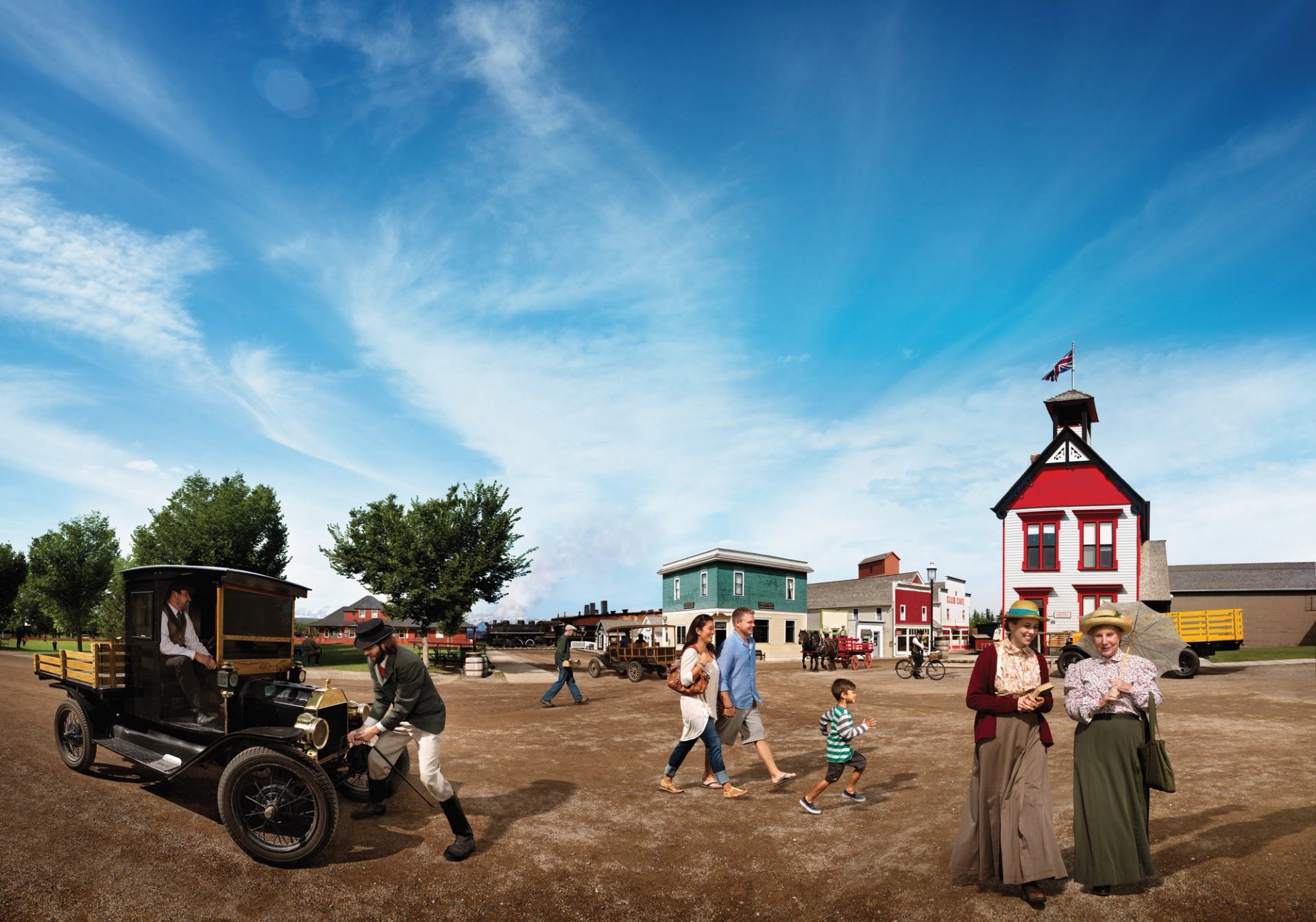 A family walking by historical actors under a blue sky at Heritage Park in Calgary.