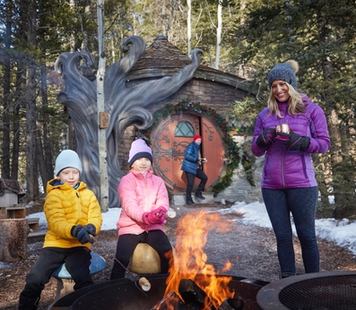 Family roasting marshmallows at Charmed family resort