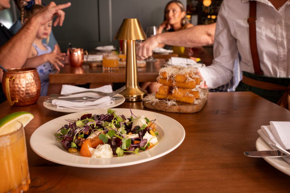 A salad with a deep fried appetizer is served at The Fat Ox in Banff.