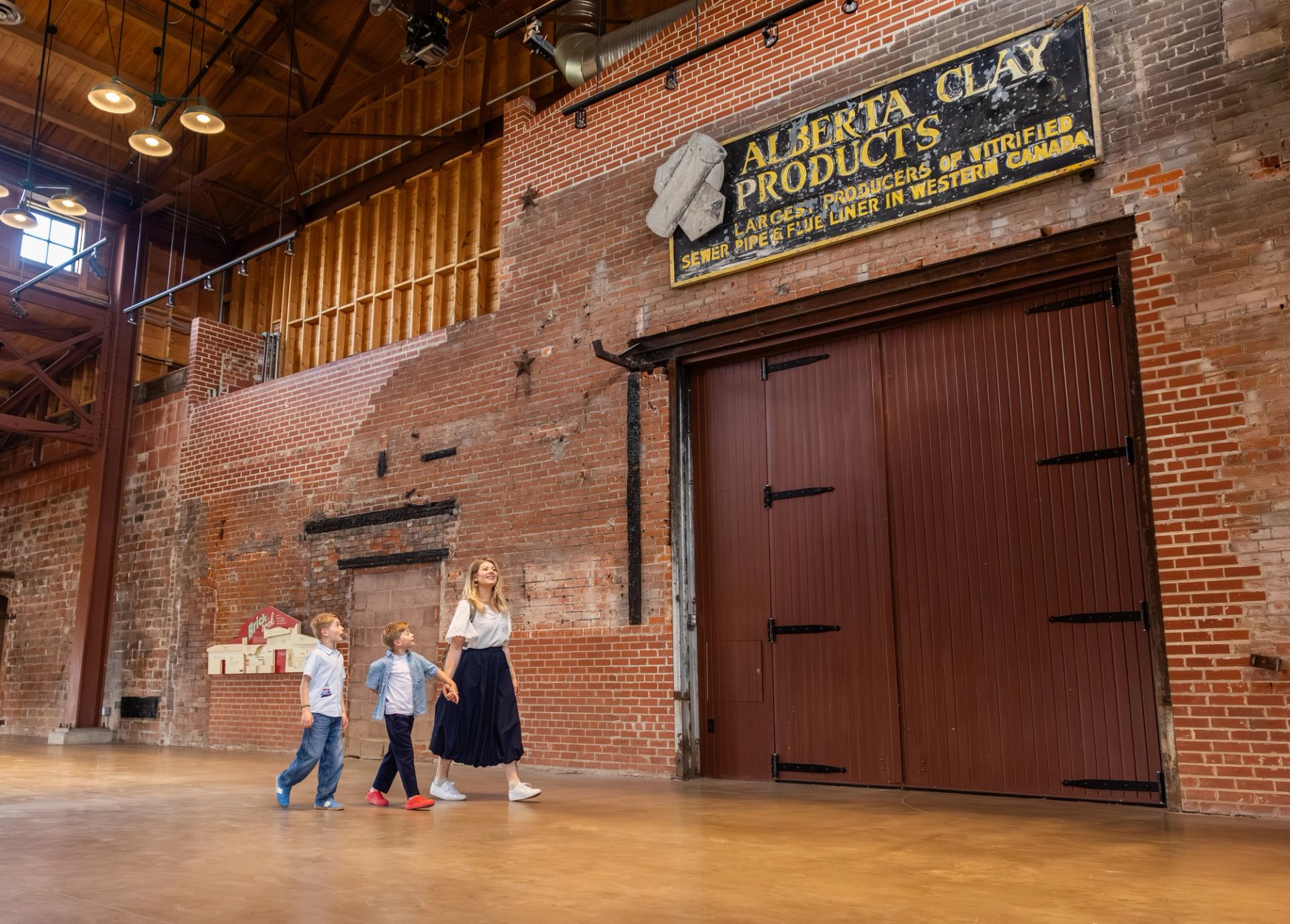 A family walk along a hallway at Medalta.
