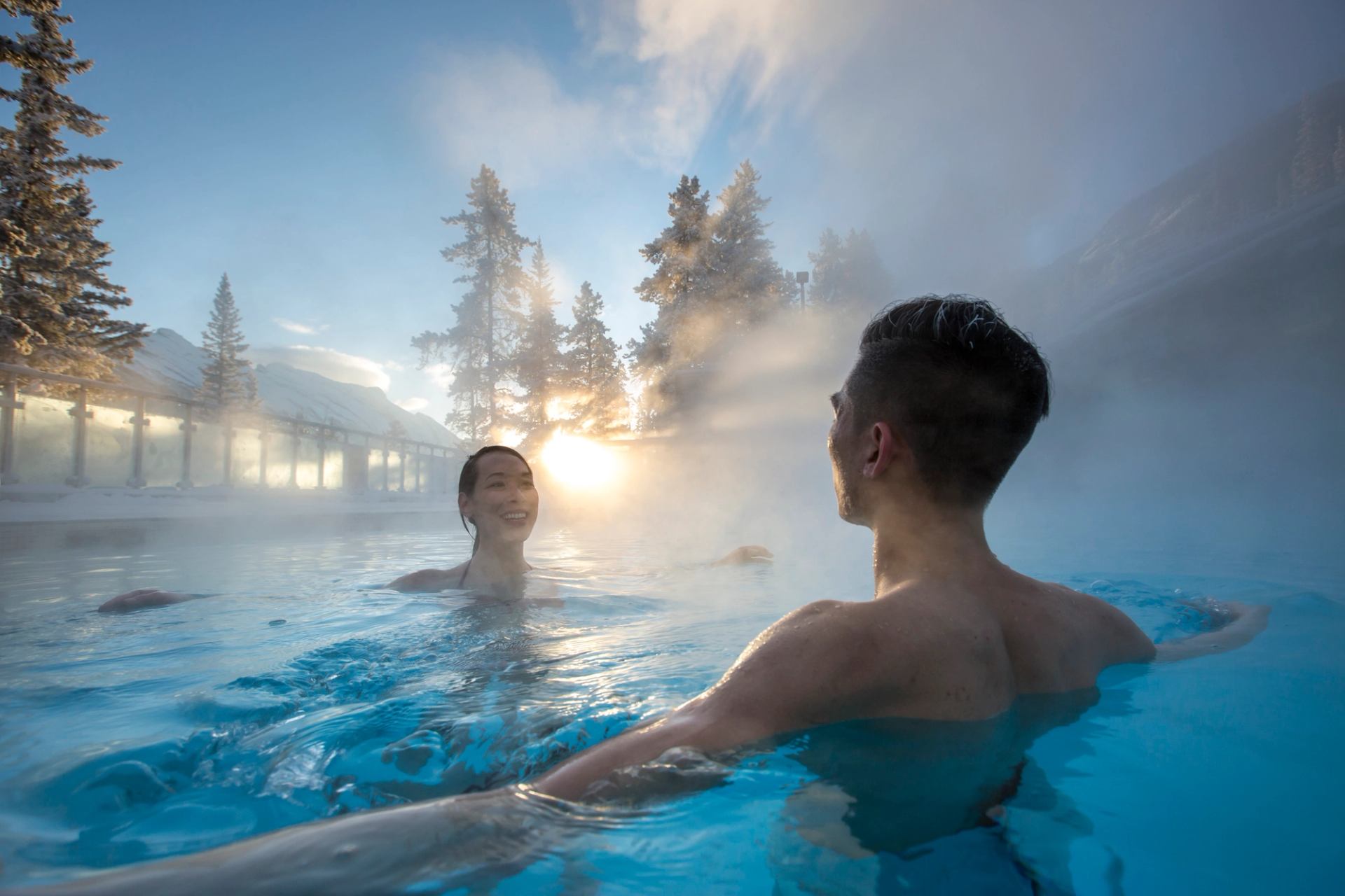 A couple relax and enjoy in the Upper Hot Springs in Banff National Park.