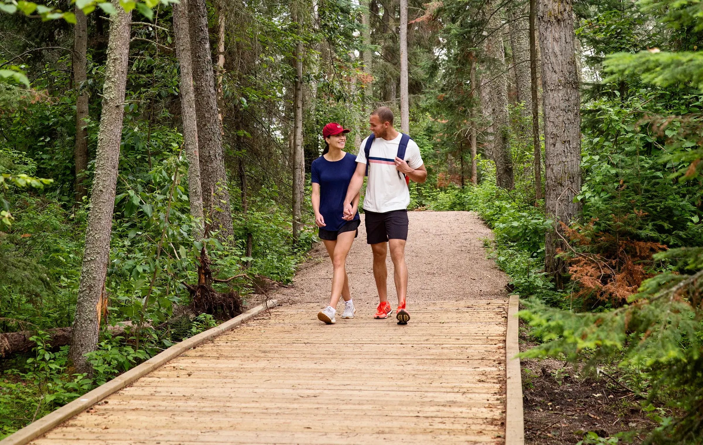 couple walking down boardwalk