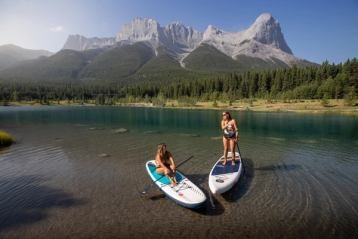 two women stand up paddle boarding quarry lake canmore