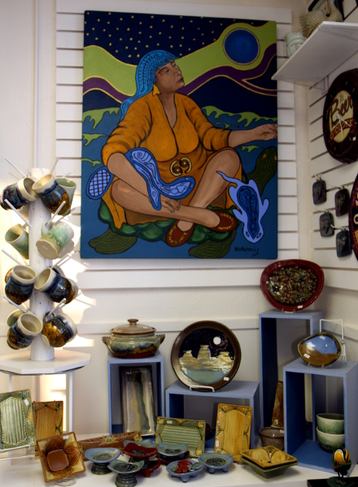 Painting and ceramics on display at an art gallery.