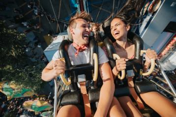 Couple smiling at each other while on a midway ride at the Calgary Stampede.