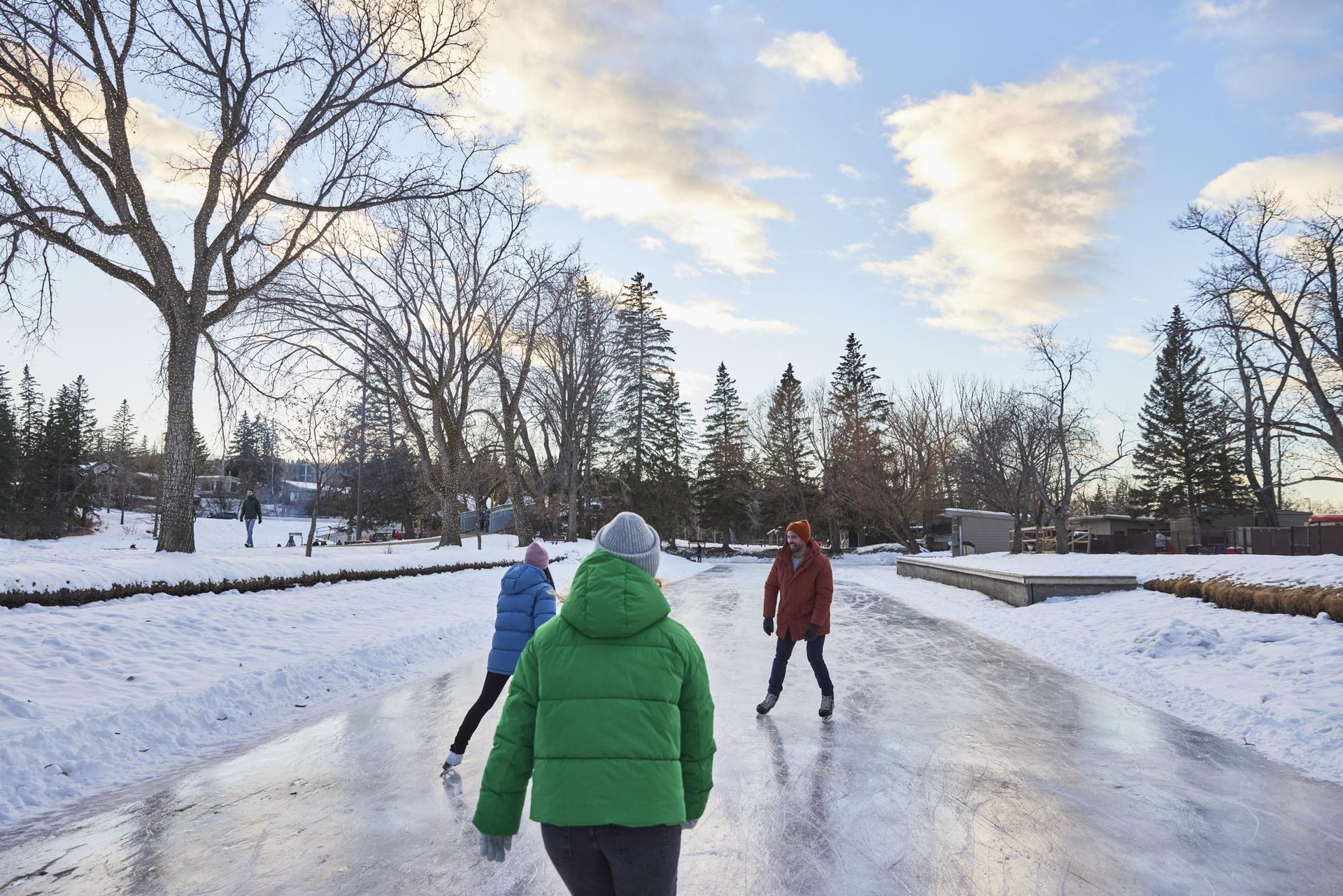 People skate on an ice trail through Bowness Park in Calgary.