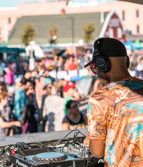 DJ playing music at an outdoor festival