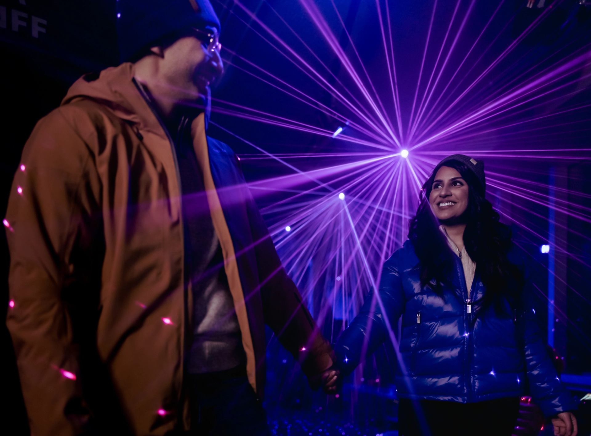 A couple enjoys the light show at Pursuit's Nightrise Experience at the Banff Gondola.