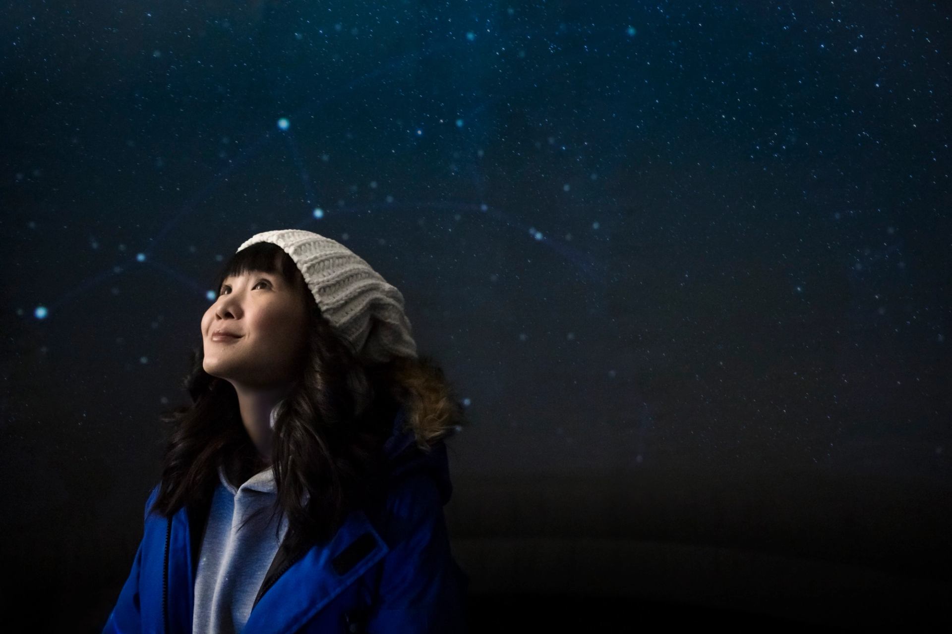 Young woman viewing projected constellations