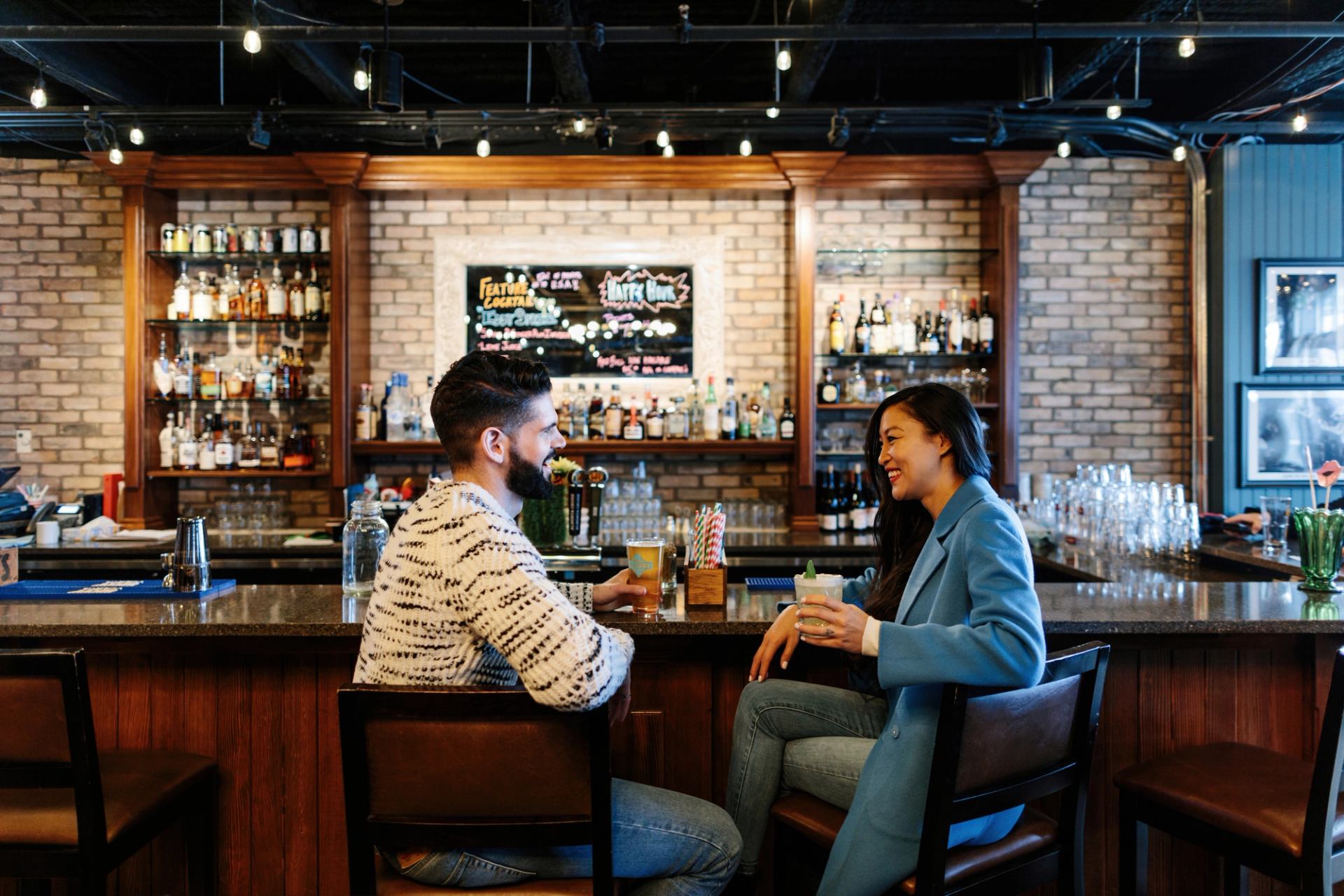 Couple having a drink at the King Eddy after exploring Studio Bell National Music Centre in Calgary.