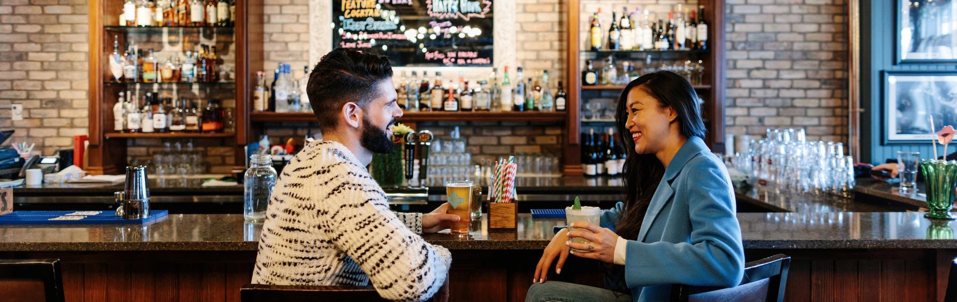 Couple having a drink at the King Eddy after exploring Studio Bell National Music Centre in Calgary.