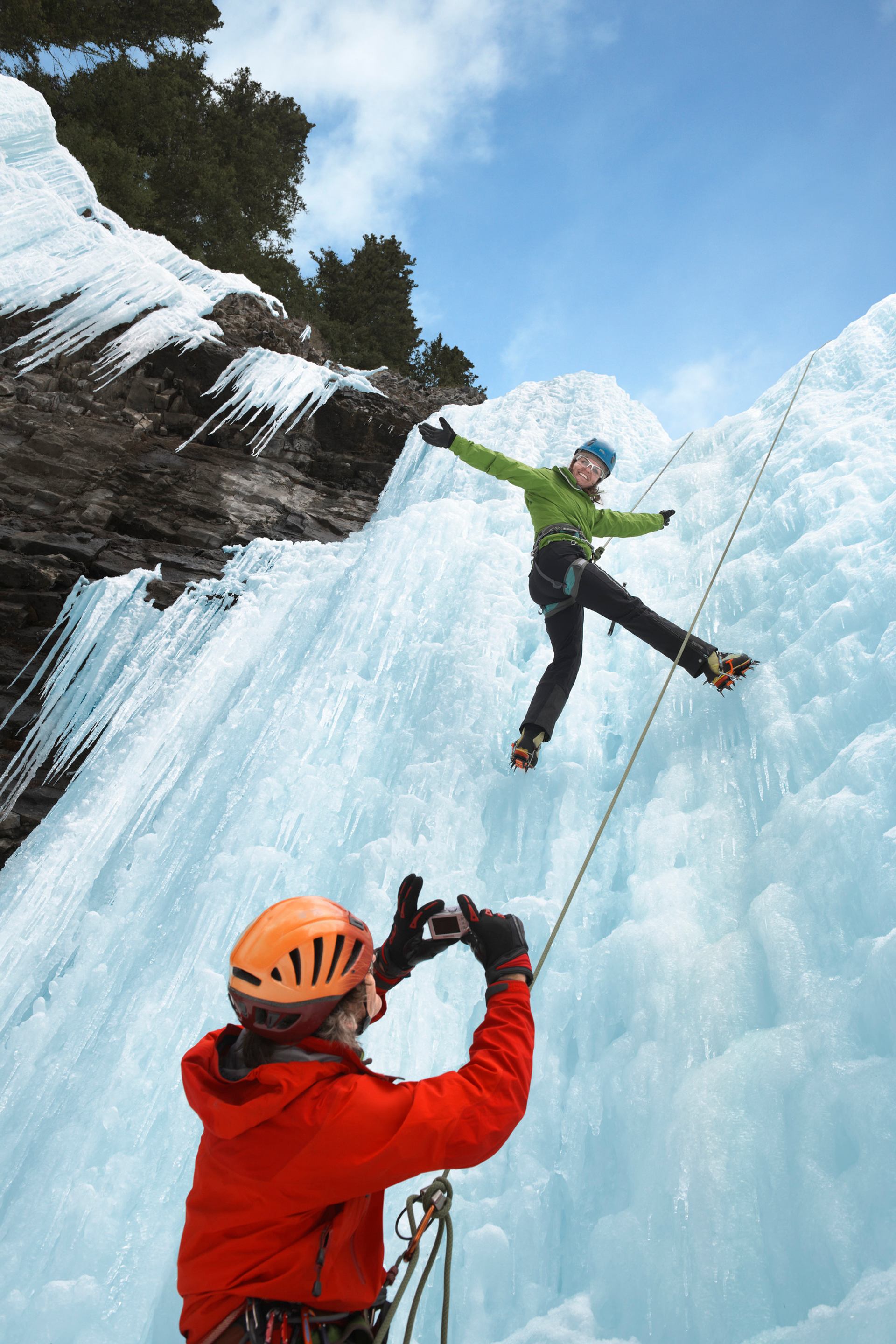 Posing for and taking pictures while ice climbing in Johnston Canyon in Banff National Park.