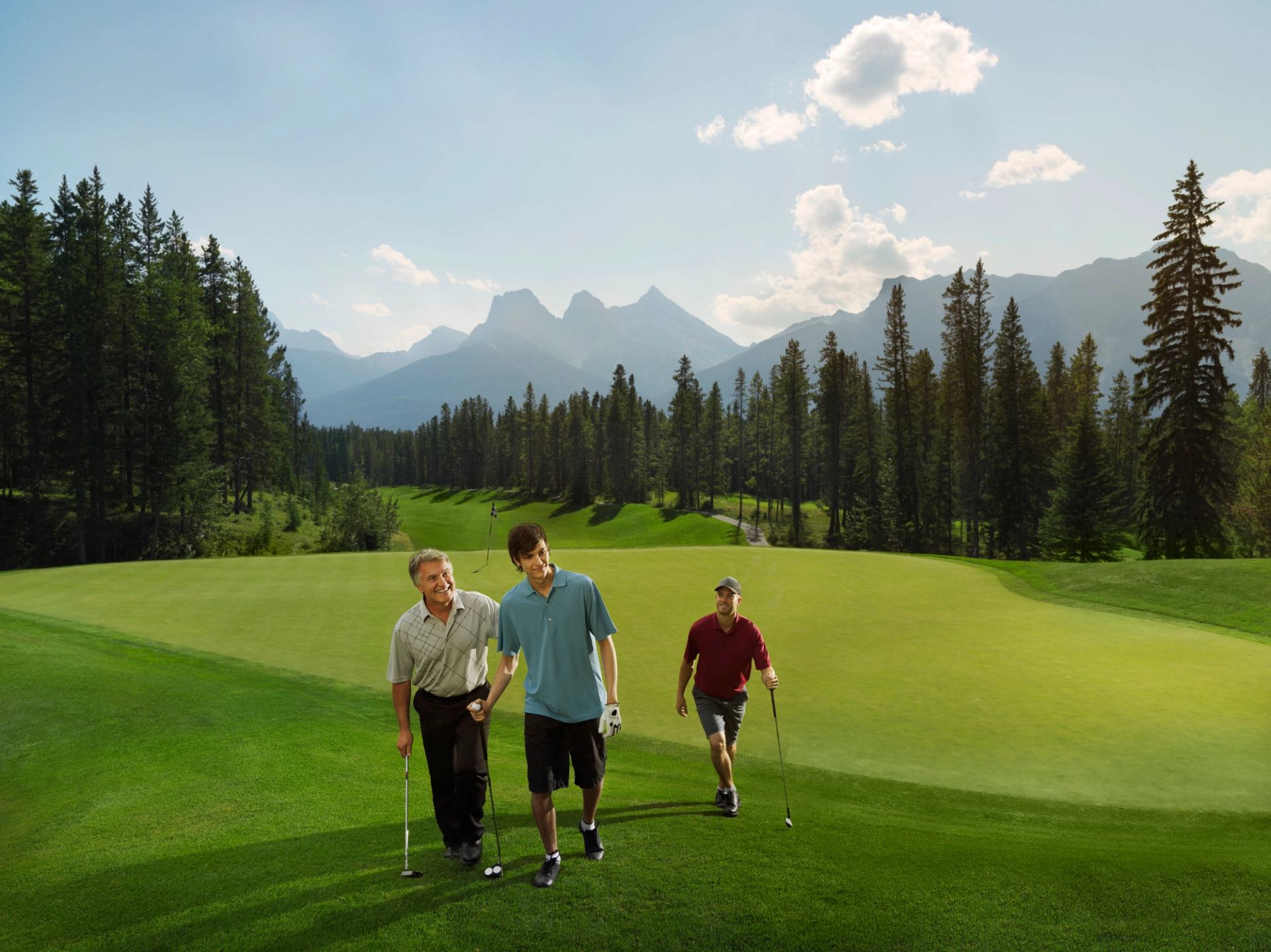 Three men golfing at the Silvertip Golf Course in Canmore