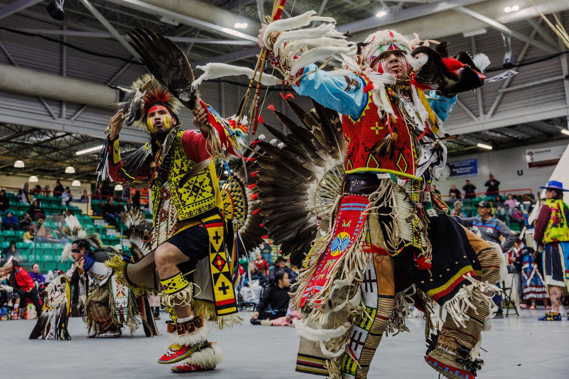 Two powwow dancers performing during a powwow competition.
