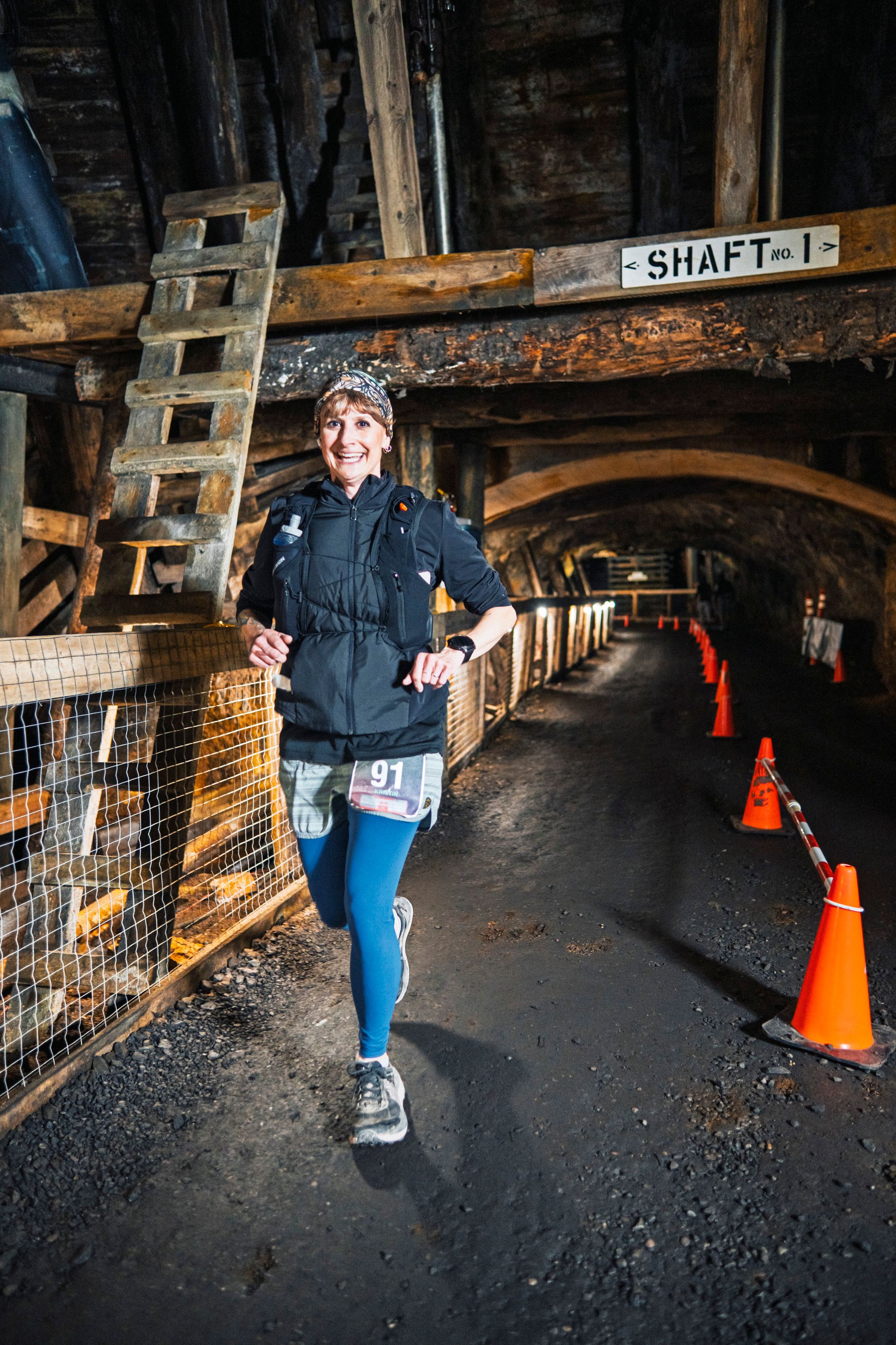 A smiling runner prepares to turn around for another lap through the Bellevue Underground Mine.