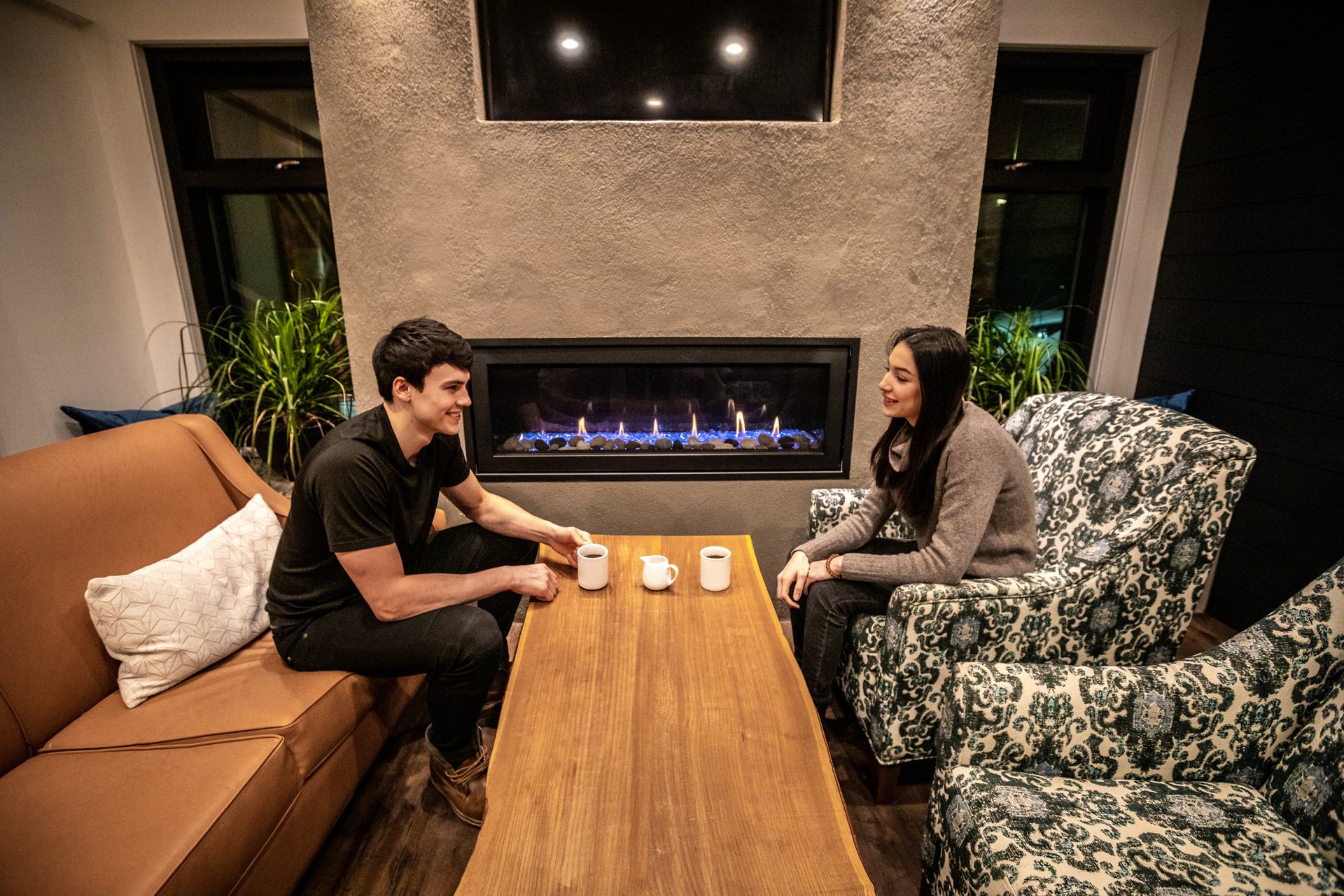 A couple relaxes at Waterton Glacier Suites in Waterton Lakes National Park.