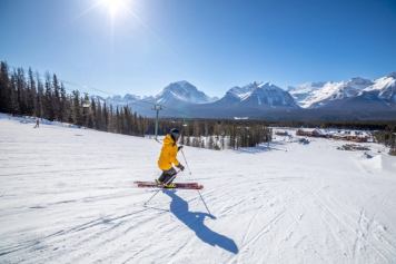 A skier skiing down an intermediate run at Lake Louise Ski Resort in Banff National Park
