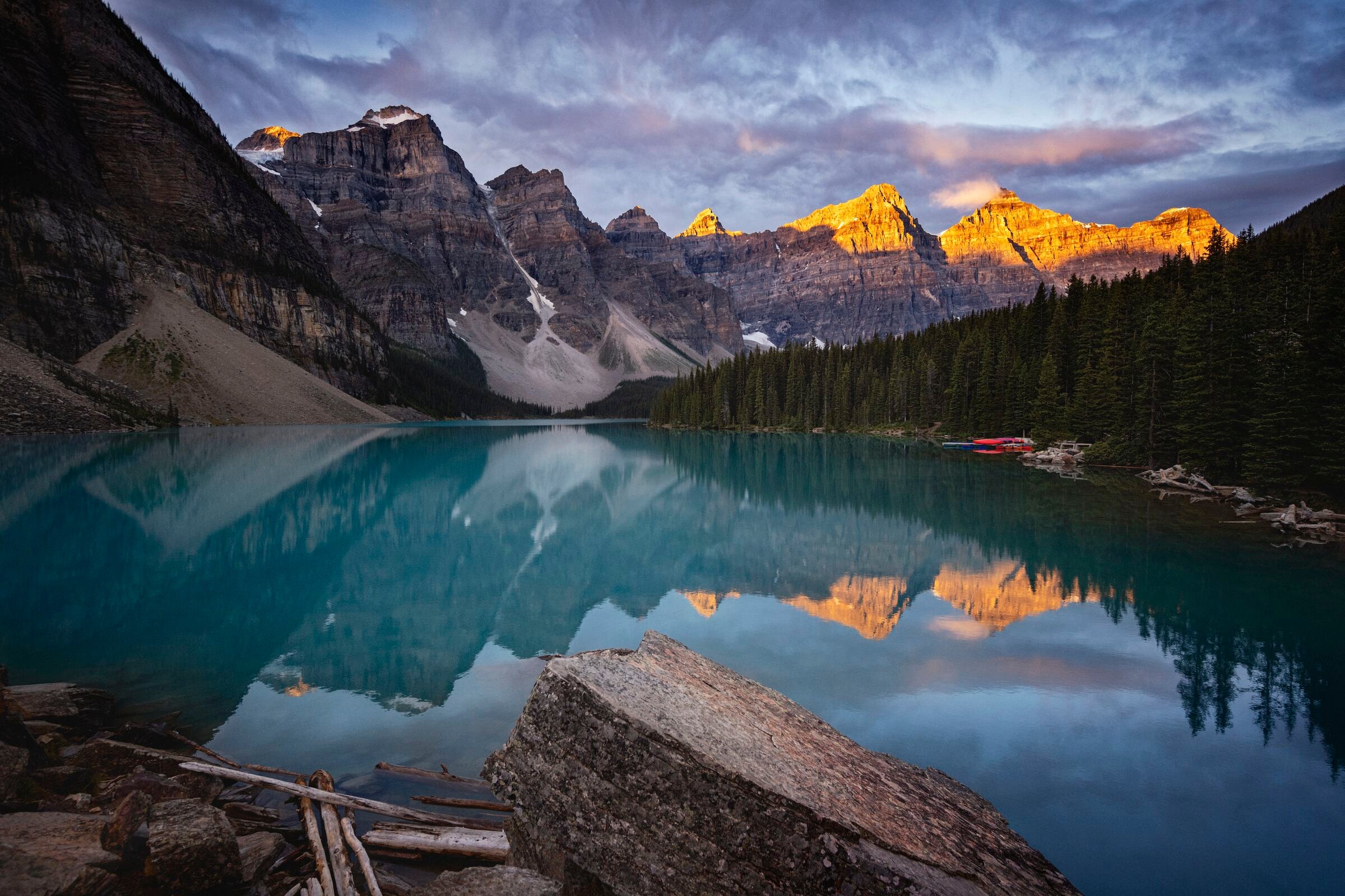 Two people paddleboarding on a glacial lake.