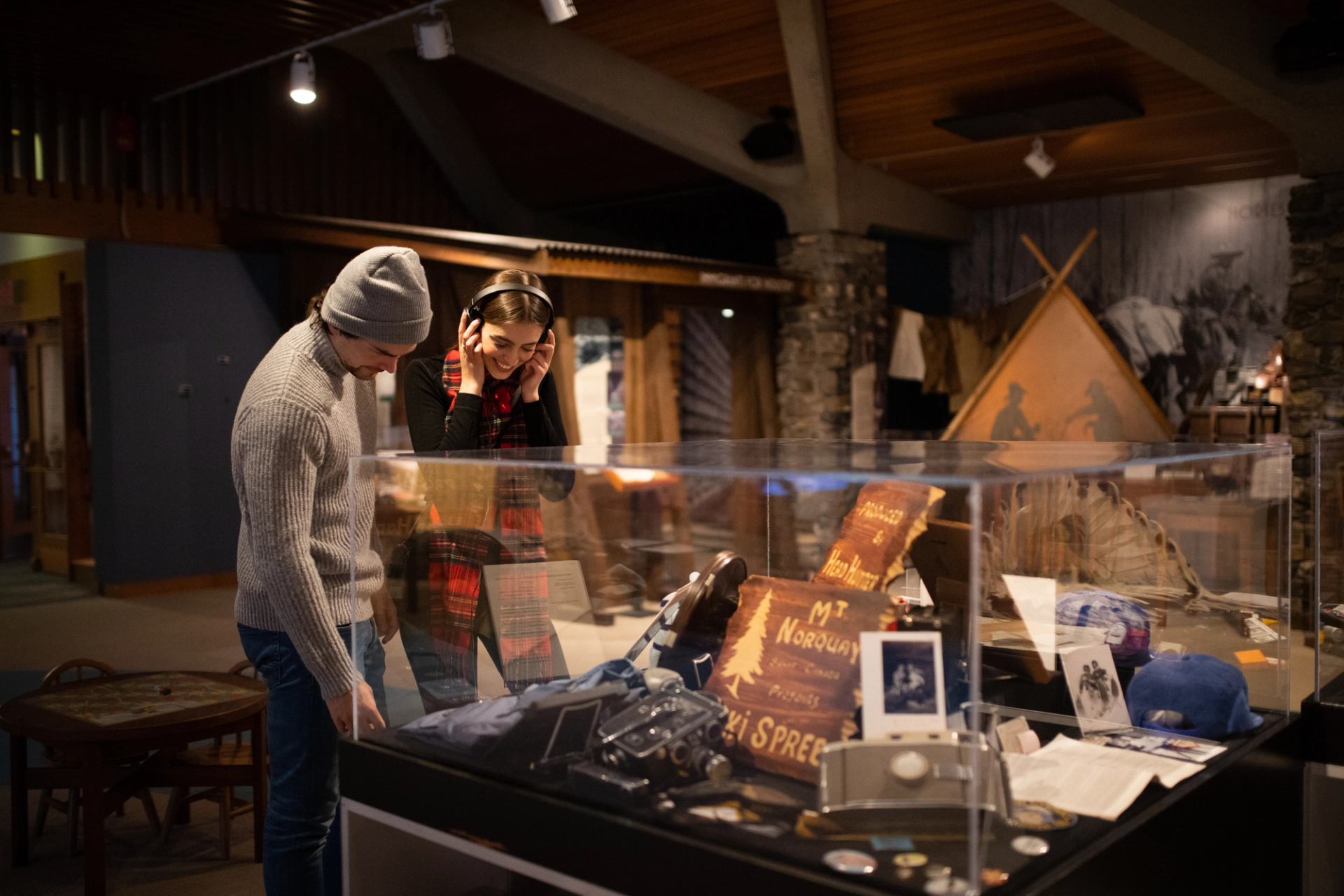 A couple looks at a glass case with artifacts.